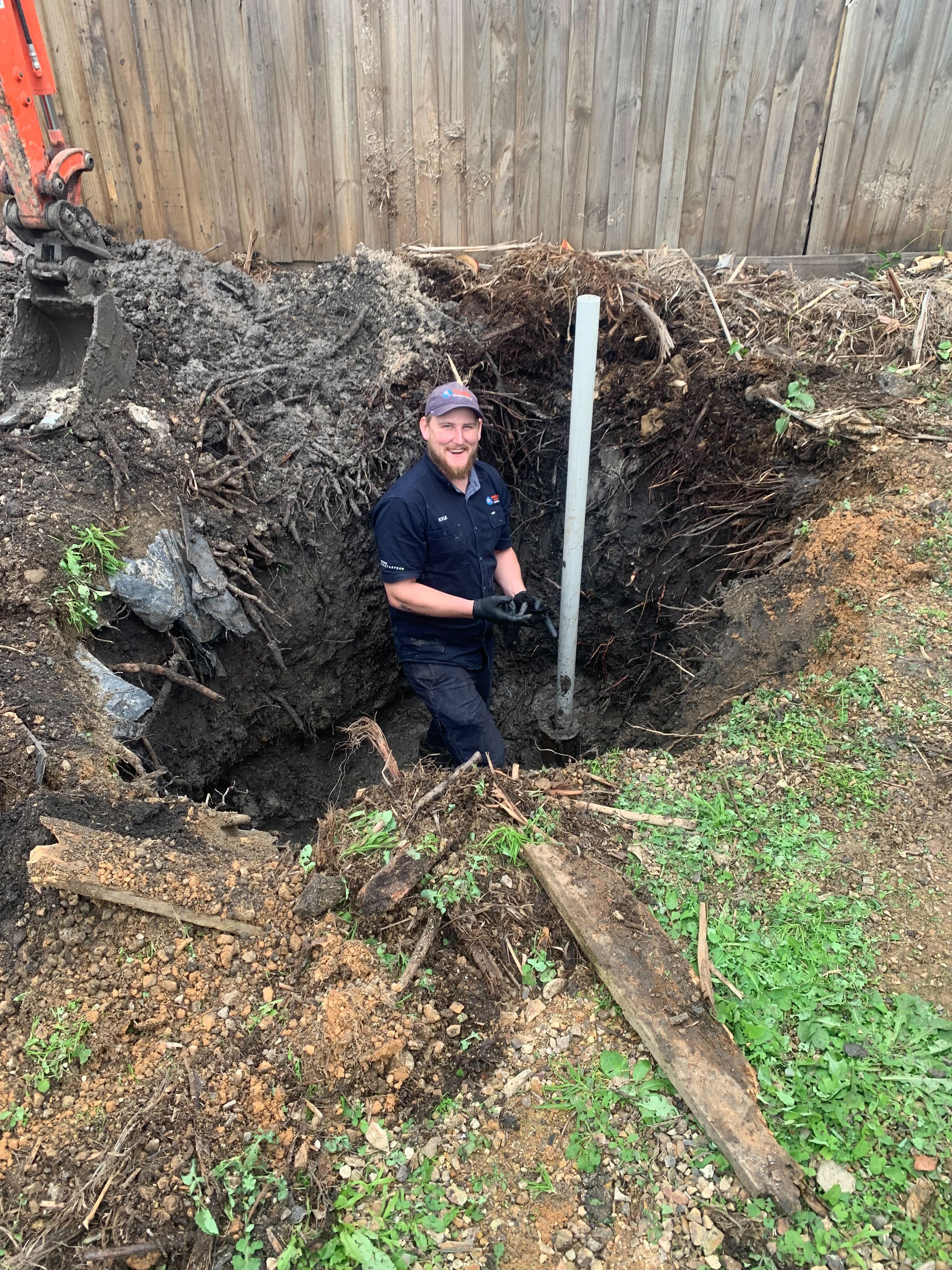 Fix-It Right plumber excavating to repair a burst pipe